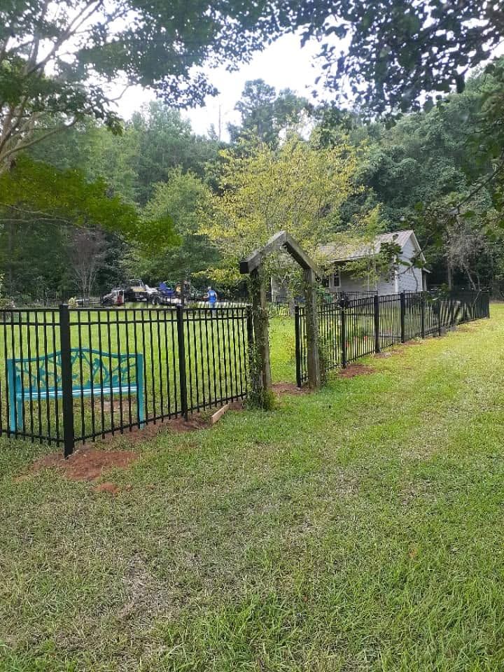 About 350 feet of black aluminum fence with garden arbor