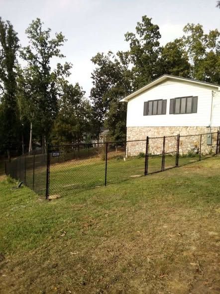 5 foot black vinyl coated chain link on a hillside lot