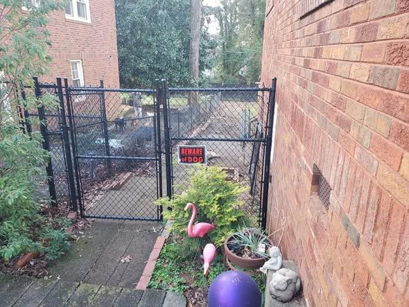 Extended black chain link fence with new 6 foot gate