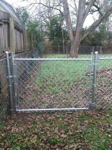 Chain link walk gate keeping the yard secure for pets