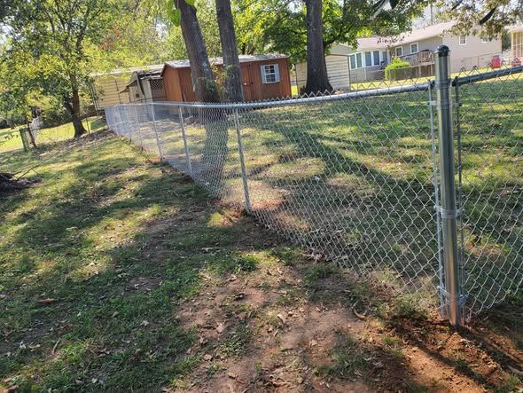 4 foot galvanized chain link fence along a backyard property line
