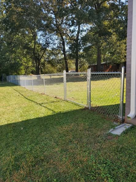 Galvanized chain link fence corner with walk gate