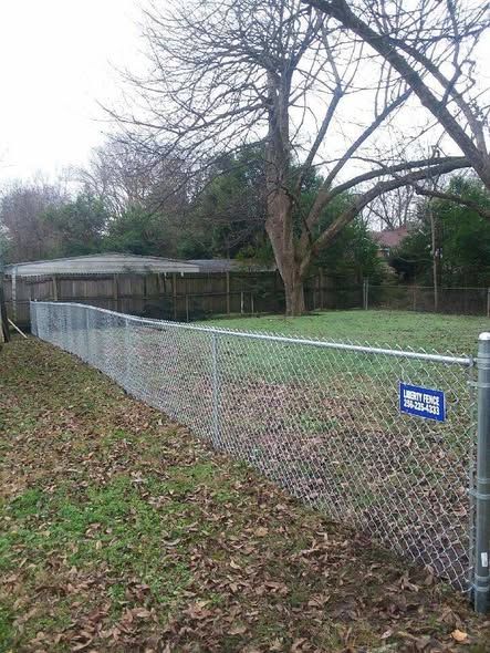 Galvanized chain link pet fence with Liberty Fence sign