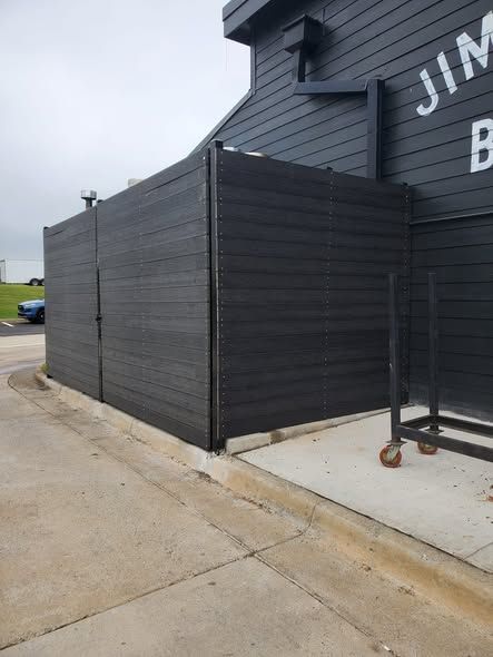 Matching dumpster gates and security rail at Jim 'N Nick's in Oxford