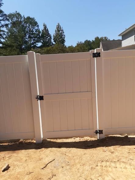 White vinyl walk gate with black hinges and latch
