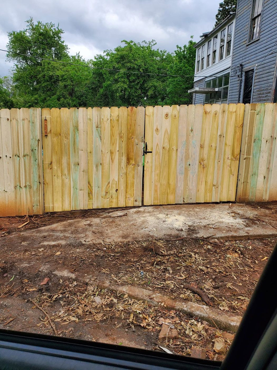 Wood privacy fence and drive gates viewed from the alley