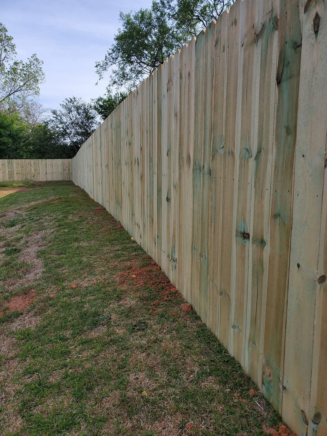 Long wood privacy fence run turning the back corner