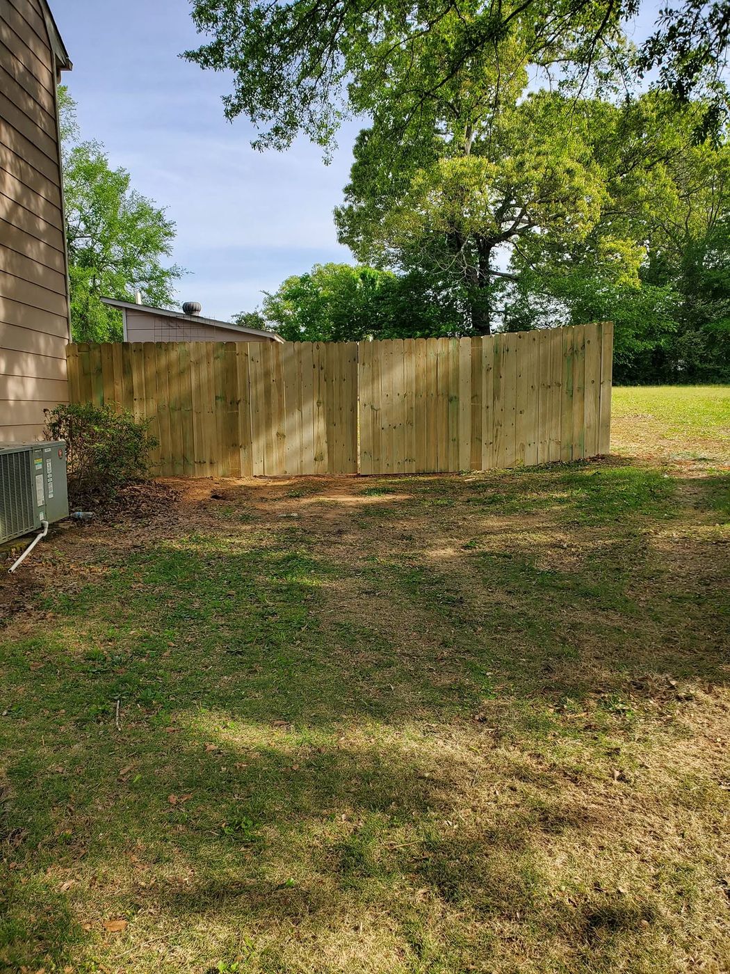 New wood privacy fence sections before the gate is hung