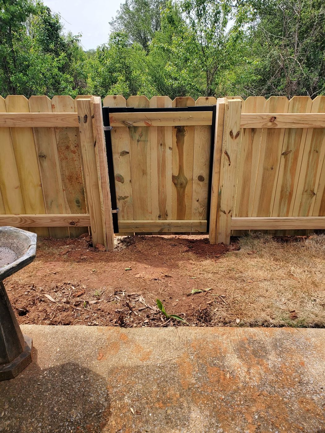 Wood privacy fence walk gate on a black steel frame